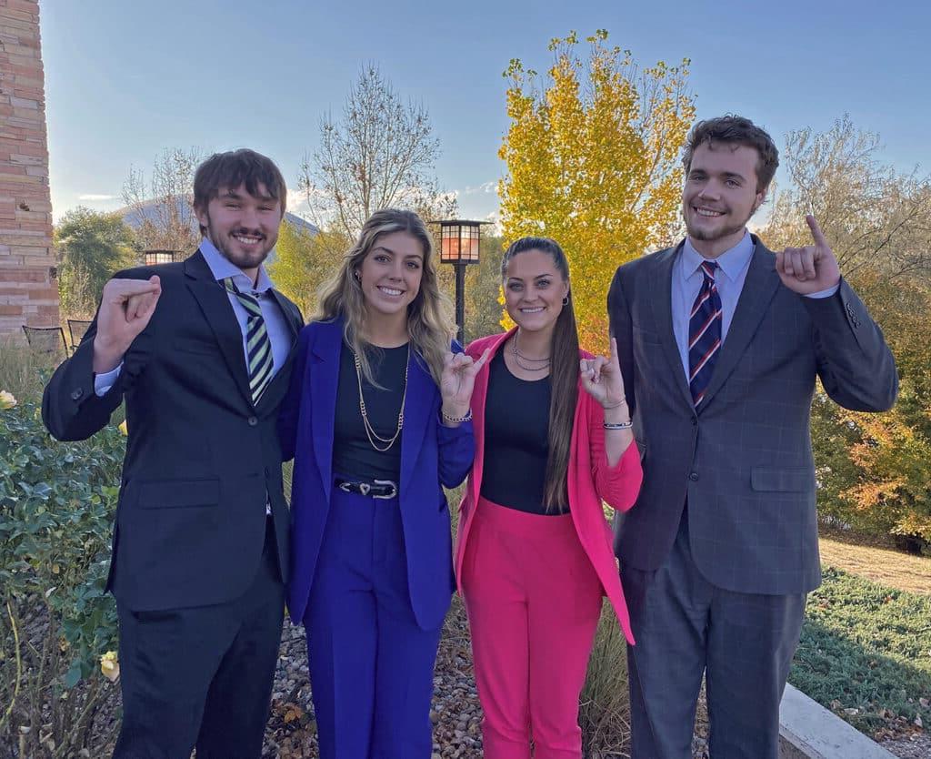 HPU’s Moot Court team consists of (from left) Mo Goff, Alli Harvey, Amber Williams and Cyah Daniel. The students show their HPU Yellow Jacket spirit by displaying the university’s “Sting ’em” hand gesture.